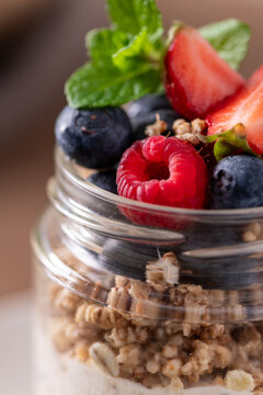 Fresh Yogurt Parfait with Granola and Mixed Berries Garnished with Mint