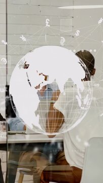 Vertical video: Team talking finance while globe popping rotating revealing money masking faces