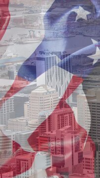 Vertical video: First frame showing port skyline starting US flag waving and blending evoking pride