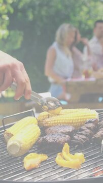 Vertical video: Cook hand entering left, flipping corn, basting peppers, checking burgers for ads