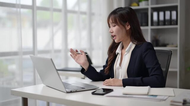 Businesswoman having video conference on laptop in office