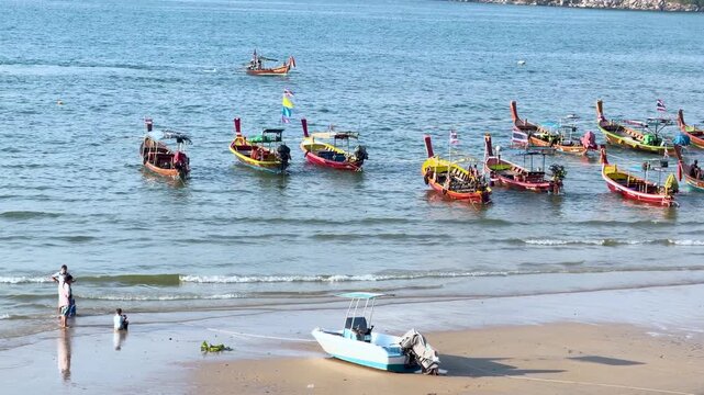 Longtail boats floating in tropical Andaman sea at Patong beach Phuket Thailand.