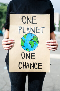 Demonstrator on the city protesting against climate change and pollution - Global warming and environment concept - Focus on banner