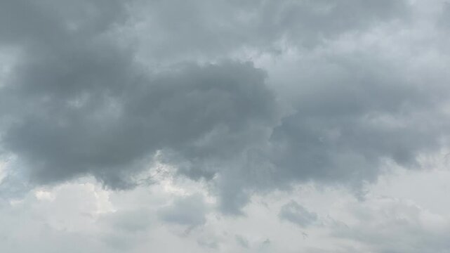 A dramatic and moody sky filled with heavy, dark storm clouds casting a sense of impending weather change