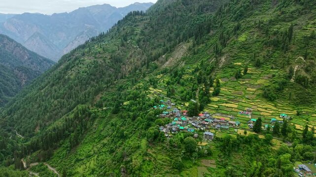 Grahan village with terraced fields, forested slopes, and layered Himalayan mountains, India