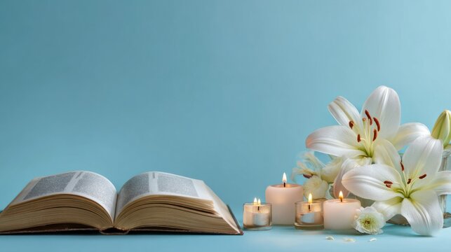 Open bible with a white lily flower and lit candles for easter holy reflection and spiritual worship