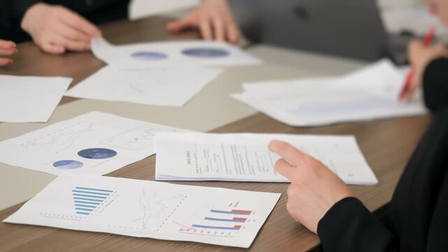 Business team analyzing financial reports and charts on table data analytics and corporate performance review concept.