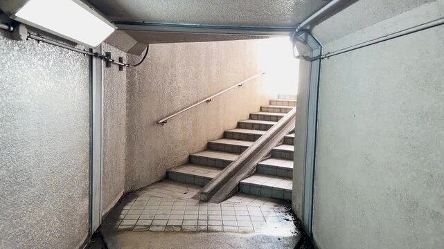 Concrete Pedestrian Underpass Staircase Leading to Bright Daylight in Kanazawa