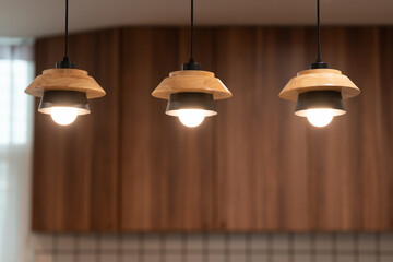 Set of Three Modern Nordic Pendant Lights with Wood and Metal Design. interior design inspiration, home decor, and modern kitchen or dining area concepts. © Wongsakorn