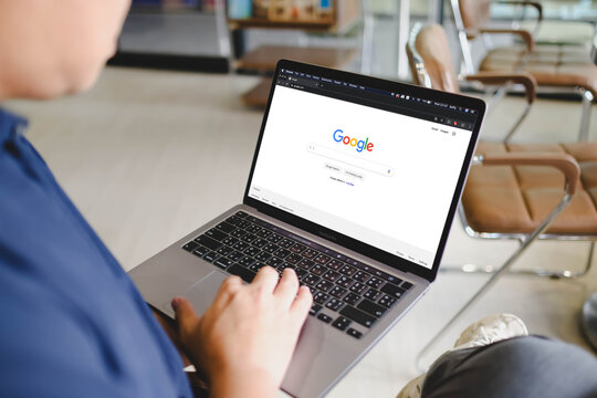 Bangkok, Thailand. April 27, 2026; A man sitting in a bright workspace is using a laptop to browse the Google search engine homepage.