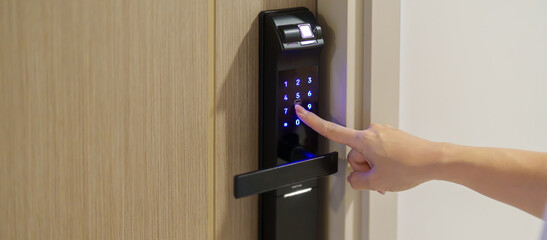 Hand press PIN number for smart digital door lock while open or close the door at home or apartment. NFC Technology, Fingerprint scan, keycard, smartphone and contactless lifestyle concepts © Jo Panuwat D