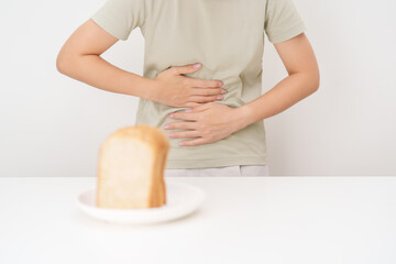 Naklejka premium Gluten intolerance, Gluten free and celiac disease or Wheat allergy. woman with wheat bread and having abdominal pain after eat gluten. stomach ache, Nausea, Bloating, Gas, Diarrhea and Skin rash