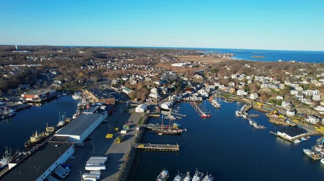 Forward drone fly over Jodrey State Fish Pier at Inner Harbor marina filled with anchored boats, Gloucester, Massachusetts, US