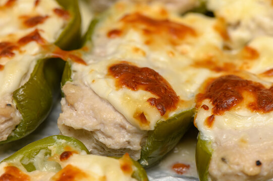 Savory stuffed peppers topped with melty cheese ready to delight the taste buds at a lively gathering