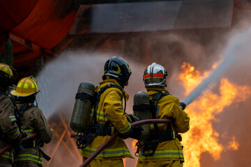 Team of firefighter in fireproof cloth using fog watering hose to put out the burning crashing plane with high flame for fire extinguish risk rescue mission and accident © Akarawut