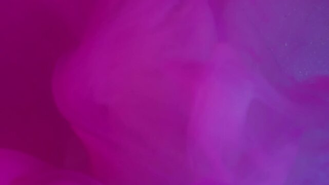 Vertical video. Neon paint. Swirling mist. Defocused pink blue purple color filling broken light bulb spreading on abstract acrylic art background.
