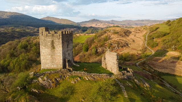 Aerial view of Dolwyddelan Castle perched on a rocky hilltop, its medieval keep and ruined walls bathed in morning light