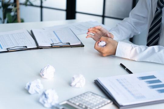 Businessman crumpled paper and throw on desk