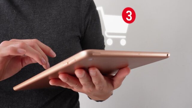 Close-up of a businesswoman interacting with her tablet, featuring a shopping cart animation and notification of the number of products added.