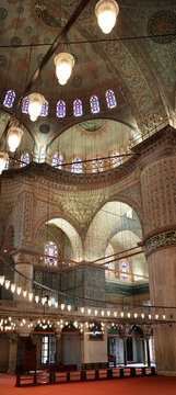 Interior of Blue Mosque Sultan Ahmed with stained glass windows and decorated dome, Istanbul, Turkey