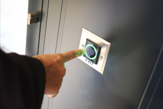 Person presses exit button to leave a building