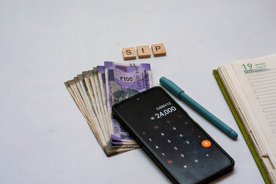 Indian Rupee Notes with Calculator and SIP Blocks Budget Planning Concept
