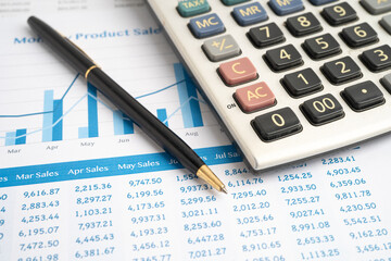 Fototapeta premium Calculator with pen on data business graphs paper.