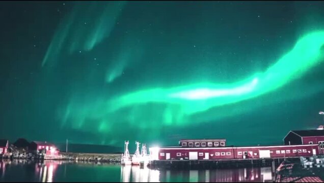 A bright, dynamic green light seemed to meander over a quiet fishing village on the edge of the pier.
