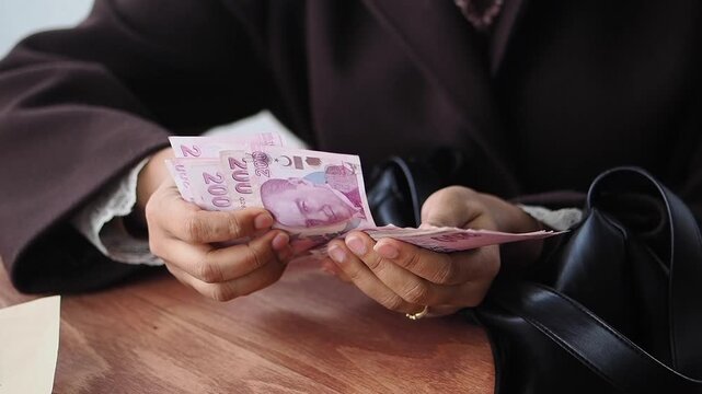 Counting cash at a cafe in the afternoon. turkish lira