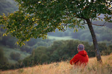Naklejka premium Man sitting in nature