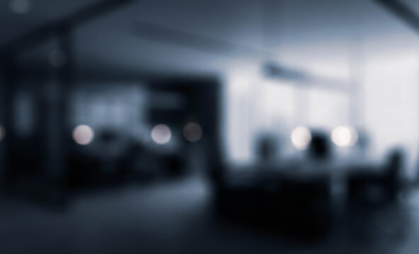 A blurry image depicting a modern office interior with soft lighting, conveying a sense of tranquility and minimalism. Ideal for corporate or workspace themes.
