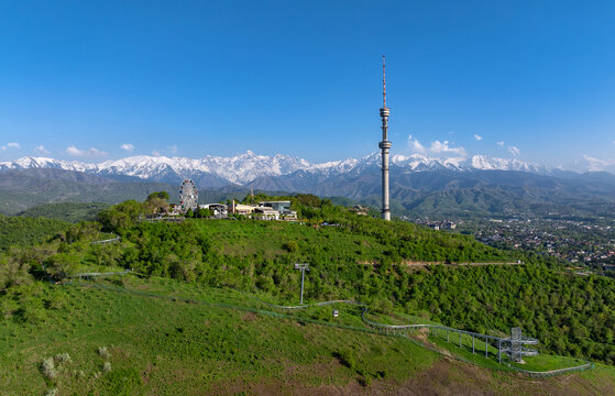 Mount Kok Tobe (Blue Hill) with the famous TV tower against the backdrop of the Zailiyskiy Alatau mountain range in the Kazakh city of Almaty on an  spring evening