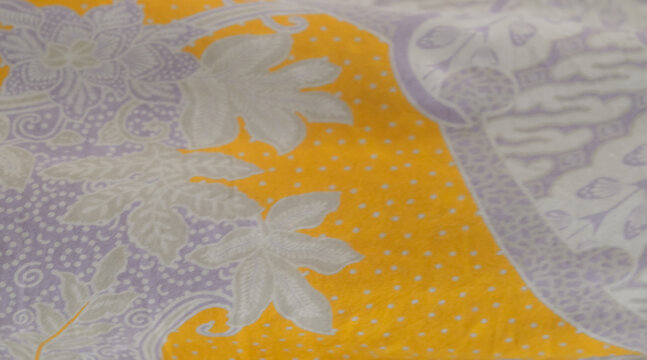 Elegant batik pattern featuring floral motifs and intricate details, showcasing traditional Indonesian textile art with a blend of soft tones and decorative elements in a refined composition
