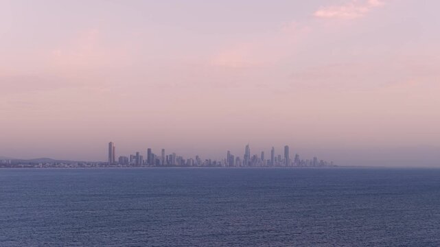 Panoramic Sunset View Of Surfers Paradise Skyline Across The Water In Gold Coast, Queensland. wide drone shot