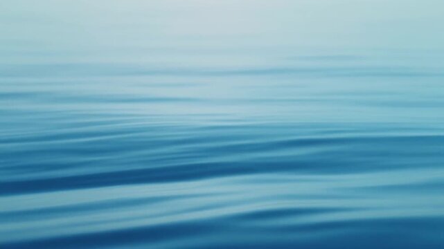 Calm ocean waves, gentle movement, shades of blue, soothing background, minimalism.