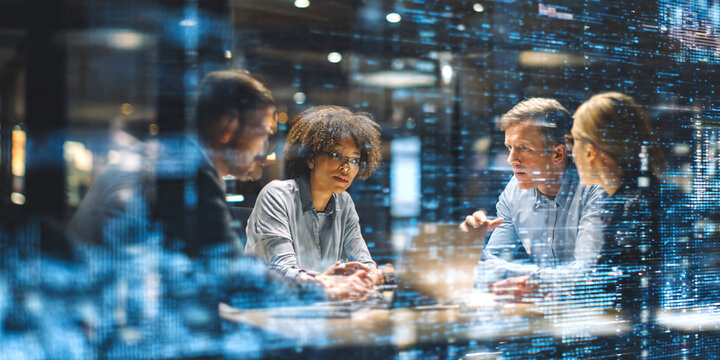 Busy modern office environment with diverse business people multitasking, collaborating, team members using laptops, smartphones and documents, networking and communication.