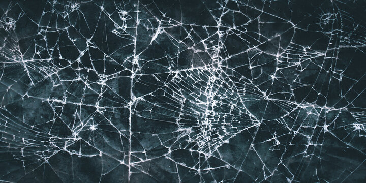 An intricate pattern of broken glass or a cracked screen. The contrasting white crack lines against the dark background create a dramatic, sharp, and textured visual.