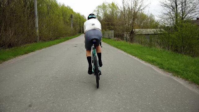 Cyclist Riding Road Bike on Asphalt Path in Countryside. Transport and Movement