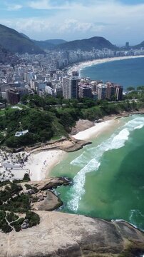 Aerial view from Piedra do Arpoador of the city of Rio de Janeiro, Copacabana, Ipanema and Christ the Redeemer on a sunny day with clear waters.