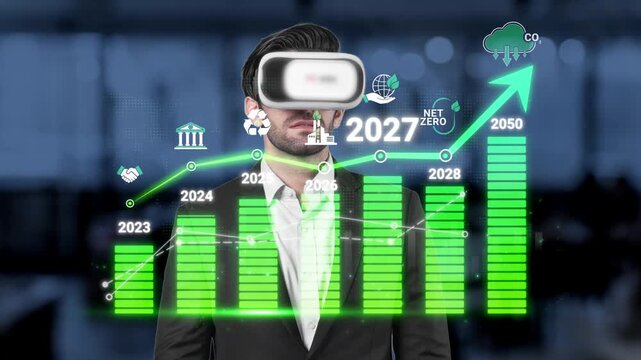 Businessman with Virtual Reality Headset Analyzing Growth Data for Net Zero Goals Towards 2050 with Graph and Icons in Modern Office Environment Sigmoid