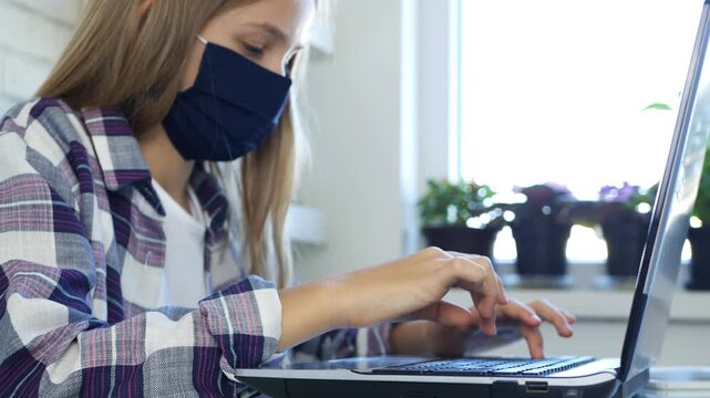 Child Wears Protective Mask in Coronavirus Pandemic Browsing Internet on Laptop, Kid Studying on Computer, School Girl Learning