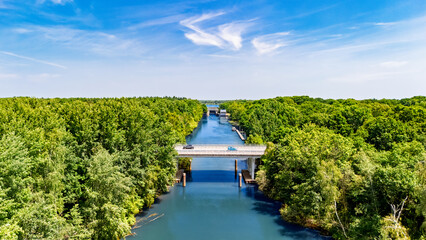 Aerial drone view of cars crossing bridge over river, forest landscape and modern road bridge, transportation and infrastructure in the Netherlands © Iuliia Sokolovska