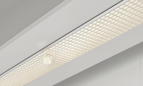 Ceiling light grid spreading warm ambient illumination in a modern minimalist interior fixture for office or home design