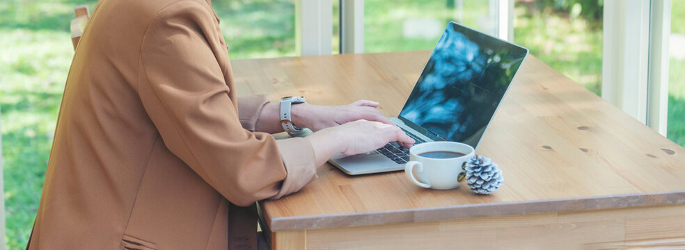 Banner Businesswoman hands type on laptop writing on notebook meeting at office desk. Freelance girl work from home via internet call conference sitting at home office morning time. Close up women