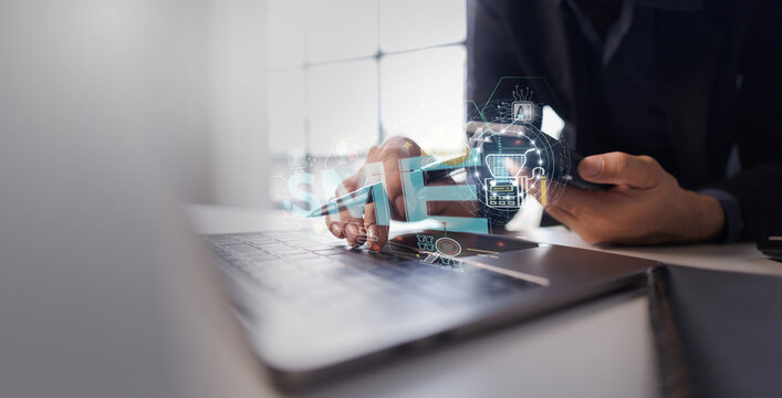 Business person using a laptop and a smartphone, demonstrating ai, digital marketing, data analytics, and sme concepts with holographic overlays for modern business solutions