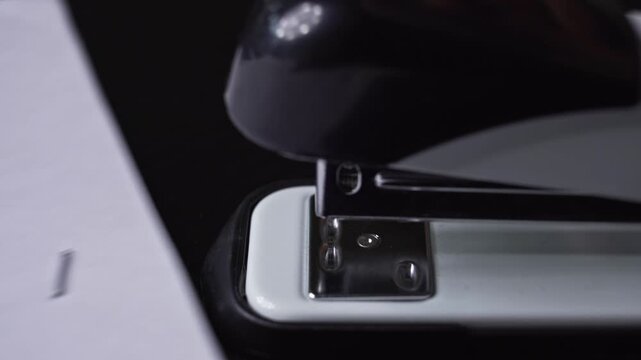 Stapling a signature page of legal document during close up office administration process