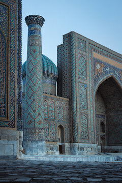 Registan Square Sher-Dor madrasah facades with turquoise tilework and minaret in Samarkand. Iconic Islamic architecture of Uzbekistan ideal for travel and cultural publications.