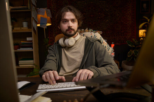 Freelancer typing on computer keyboard working late at home