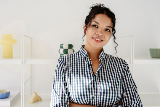 Smiling entrepreneur looking at camera in modern office