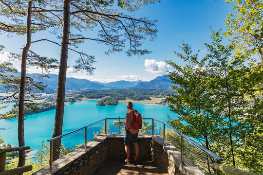 Hiker looking at Lake Faaker See from Taborhoehe in Carinthia